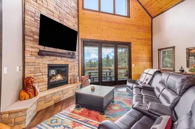 a living room with a fireplace and a tv at Eldondale -- 22-ZONE3272 home in Estes Park