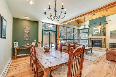 a dining room with a table and a fireplace at Keystone Ski House Gem Walk to River Run Gondola! in Keystone