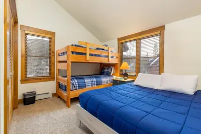 a bedroom with two beds and a bunk bed at Keystone Ski House Gem Walk to River Run Gondola! in Keystone