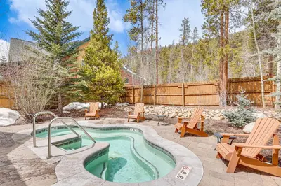a pool in a yard with chairs and a fence at Keystone Ski House Gem Walk to River Run Gondola! in Keystone