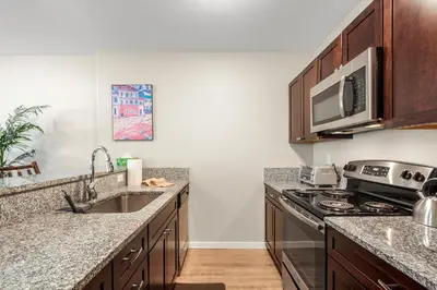 a kitchen with a sink stove and a microwave at Alpine Ridge A25 by Great Western Lodging in Dillon