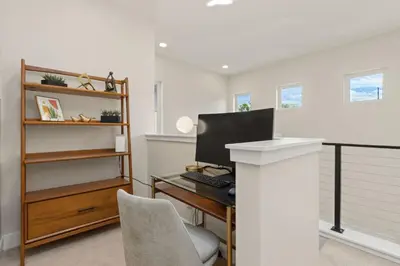 an office with a desk with a computer on it at Contemporary Gem - Rooftop Deck & Private Hot Tub! in Fort Collins