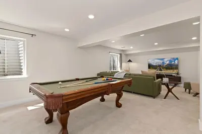 a living room with a pool table in it at Contemporary Gem - Rooftop Deck & Private Hot Tub! in Fort Collins