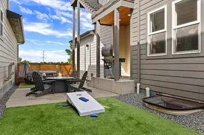 a backyard with a ping pong table and a grill at Contemporary Gem - Rooftop Deck & Private Hot Tub! in Fort Collins