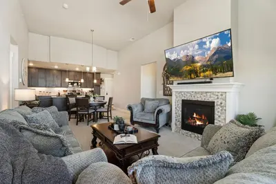 a living room with couches and a fireplace at Serene Retreat with Hot Tub, Sauna, Pool & Gym in Windsor