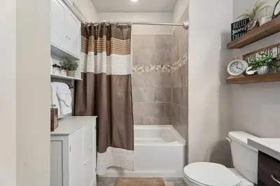 a bathroom with a shower and a toilet and a sink at Serene Retreat with Hot Tub, Sauna, Pool & Gym in Windsor