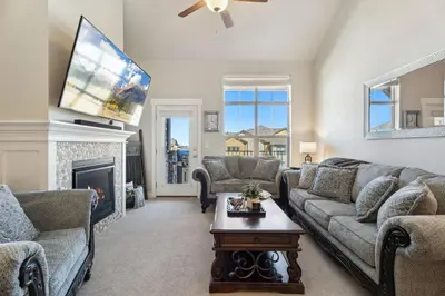 a living room with a couch and a fireplace at Serene Retreat with Hot Tub, Sauna, Pool & Gym in Windsor