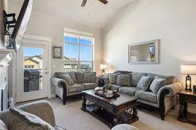 a living room with a couch and a table at Serene Retreat with Hot Tub, Sauna, Pool & Gym in Windsor