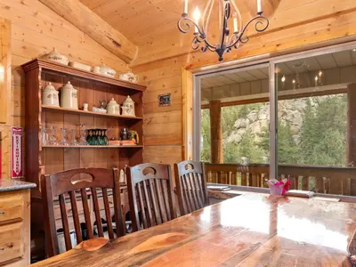 a dining room with a table and chairs in a cabin at Pine Haven Resort in Estes Park