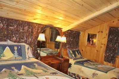 a bedroom with two beds in a cabin at Pine Haven Resort in Estes Park