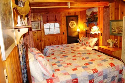 a bedroom with a bed in a cabin at Pine Haven Resort in Estes Park