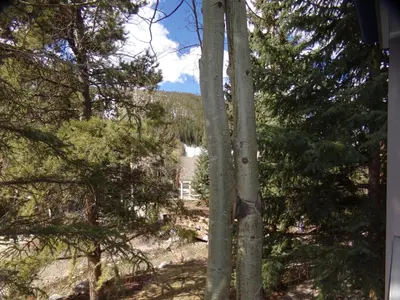 a view of a house through the trees at Chateau DuMont Oversized 2 Bed 2 Bath CDMR in Keystone