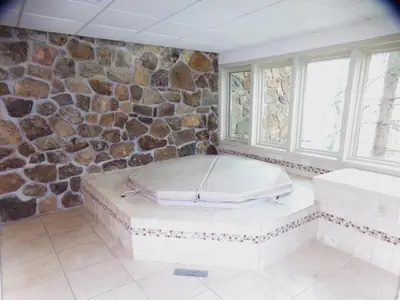 a room with a stone wall with a mattress in it at Chateau DuMont Oversized 2 Bed 2 Bath CDMR in Keystone