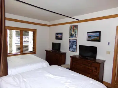 a bedroom with two beds and a television in it at Chateau DuMont Oversized 2 Bed 2 Bath CDMR in Keystone