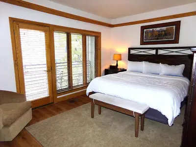 a bedroom with a bed and a couch and windows at Chateau DuMont Oversized 2 Bed 2 Bath CDMR in Keystone