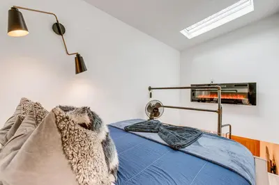 a bedroom with a bed with a blanket at Denver Tiny House Walk to Cafes, Bars, Eateries! in Denver