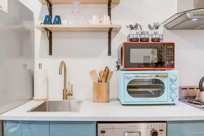 a kitchen with a microwave and a toaster oven at Denver Tiny House Walk to Cafes, Bars, Eateries! in Denver