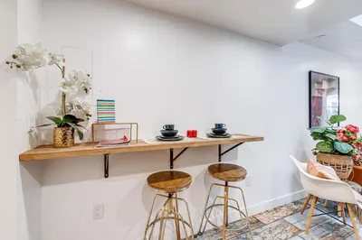 a room with two bar stools and a shelf on the wall at Denver Tiny House Walk to Cafes, Bars, Eateries! in Denver