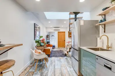 a kitchen with white walls and a table and chairs at Denver Tiny House Walk to Cafes, Bars, Eateries! in Denver
