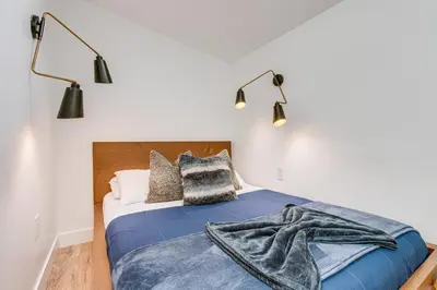 a bedroom with a bed with a blue blanket on it at Denver Tiny House Walk to Cafes, Bars, Eateries! in Denver