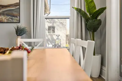 a dining room with a table and chairs and a window at Updated Central LoHi Home - Large Yard - 32nd Ave in Denver