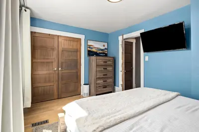 a bedroom with a bed and a flat screen tv at Updated Central LoHi Home - Large Yard - 32nd Ave in Denver