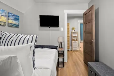 a bedroom with a bed and a flat screen tv at Updated Central LoHi Home - Large Yard - 32nd Ave in Denver