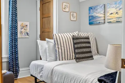 a room with a couch with pillows on it at Updated Central LoHi Home - Large Yard - 32nd Ave in Denver