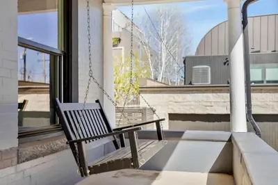 a swing on the porch of a house at Updated Central LoHi Home - Large Yard - 32nd Ave in Denver