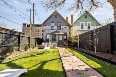 a backyard with a fence and grass at Updated Central LoHi Home - Large Yard - 32nd Ave in Denver