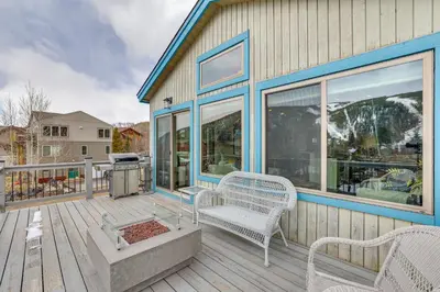 a house with a deck with a bench and a grill at Walk to Slopes Home with Hot Tub in Keystone in Keystone