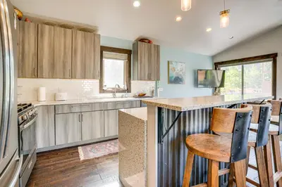 a kitchen with wooden cabinets and a counter top at Walk to Slopes Home with Hot Tub in Keystone in Keystone