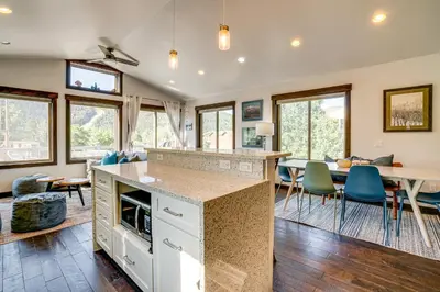 a kitchen and dining room with a table and chairs at Walk to Slopes Home with Hot Tub in Keystone in Keystone