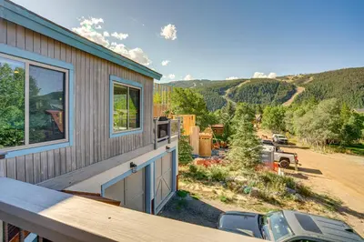 a house with a balcony with a view of a road at Walk to Slopes Home with Hot Tub in Keystone in Keystone