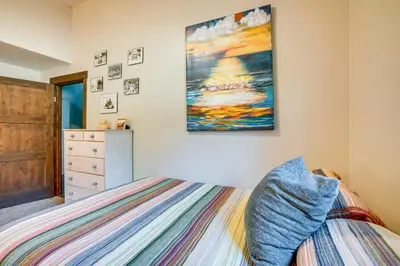 a bedroom with a bed and a painting on the wall at Walk to Slopes Home with Hot Tub in Keystone in Keystone
