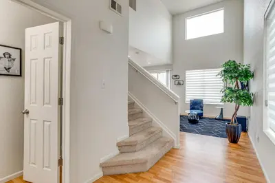 a staircase in a home with white walls at 6 Mi to DIA Denver Home with Fenced Yard and Fire Pit in Aurora