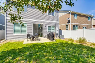 a yard with a table and chairs in front of a house at 6 Mi to DIA Denver Home with Fenced Yard and Fire Pit in Aurora