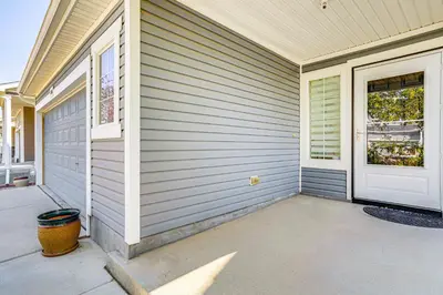 a house with a garage and a door at 6 Mi to DIA Denver Home with Fenced Yard and Fire Pit in Aurora
