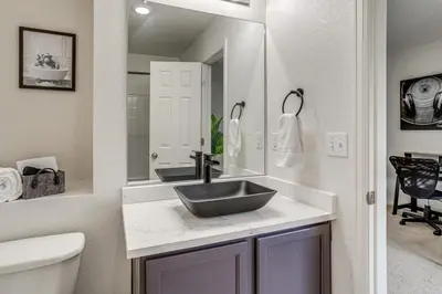 a bathroom with a sink and a mirror at 6 Mi to DIA Denver Home with Fenced Yard and Fire Pit in Aurora
