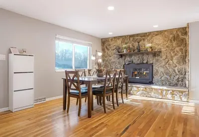 a dining room with a table and a fireplace at Sweet Arvada Escape - Near Olde Town in Arvada