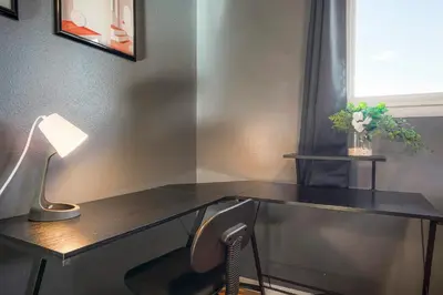 a glass desk with a lamp and a chair at Sweet Arvada Escape - Near Olde Town in Arvada