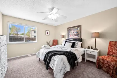 a bedroom with a bed and a ceiling fan at Wagon Trail in Littleton