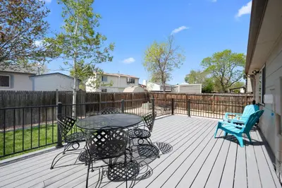 a patio with a table and chairs and a bench at Wagon Trail in Littleton