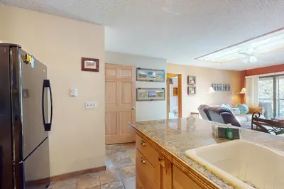a kitchen with a sink and a refrigerator at Frosty Peak Perch in Fraser