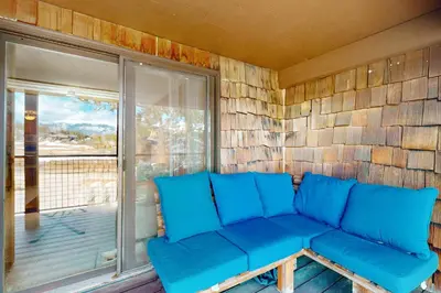 a blue couch in a room with a window at Frosty Peak Perch in Fraser
