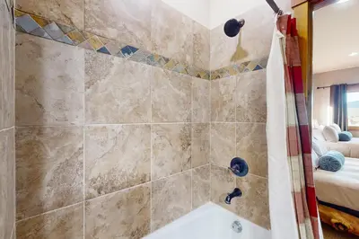 a bathroom with a shower and a bath tub at Bergamont Bliss in Tabernash