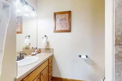 a bathroom with a sink and a mirror at Bergamont Bliss in Tabernash