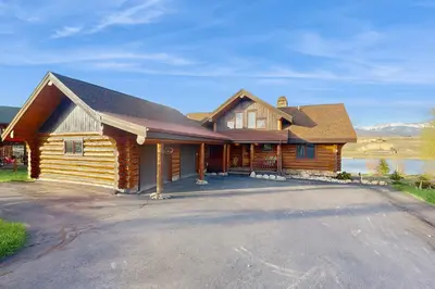 a log house with a driveway in front of it at Bergamont Bliss in Tabernash