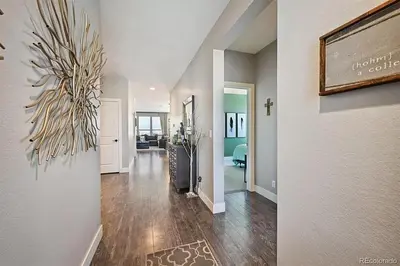 a hallway of a home with a painting on the wall at 4BR Home close to Airport in Aurora