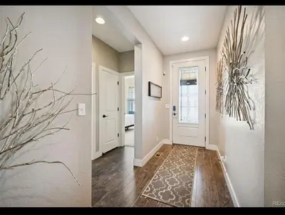 two pictures of a hallway in a home at 4BR Home close to Airport in Aurora
